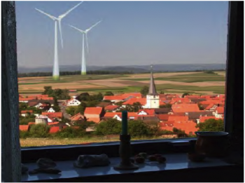 wind turbines next to a European village
