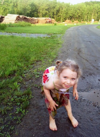 Young girl playing in the mud